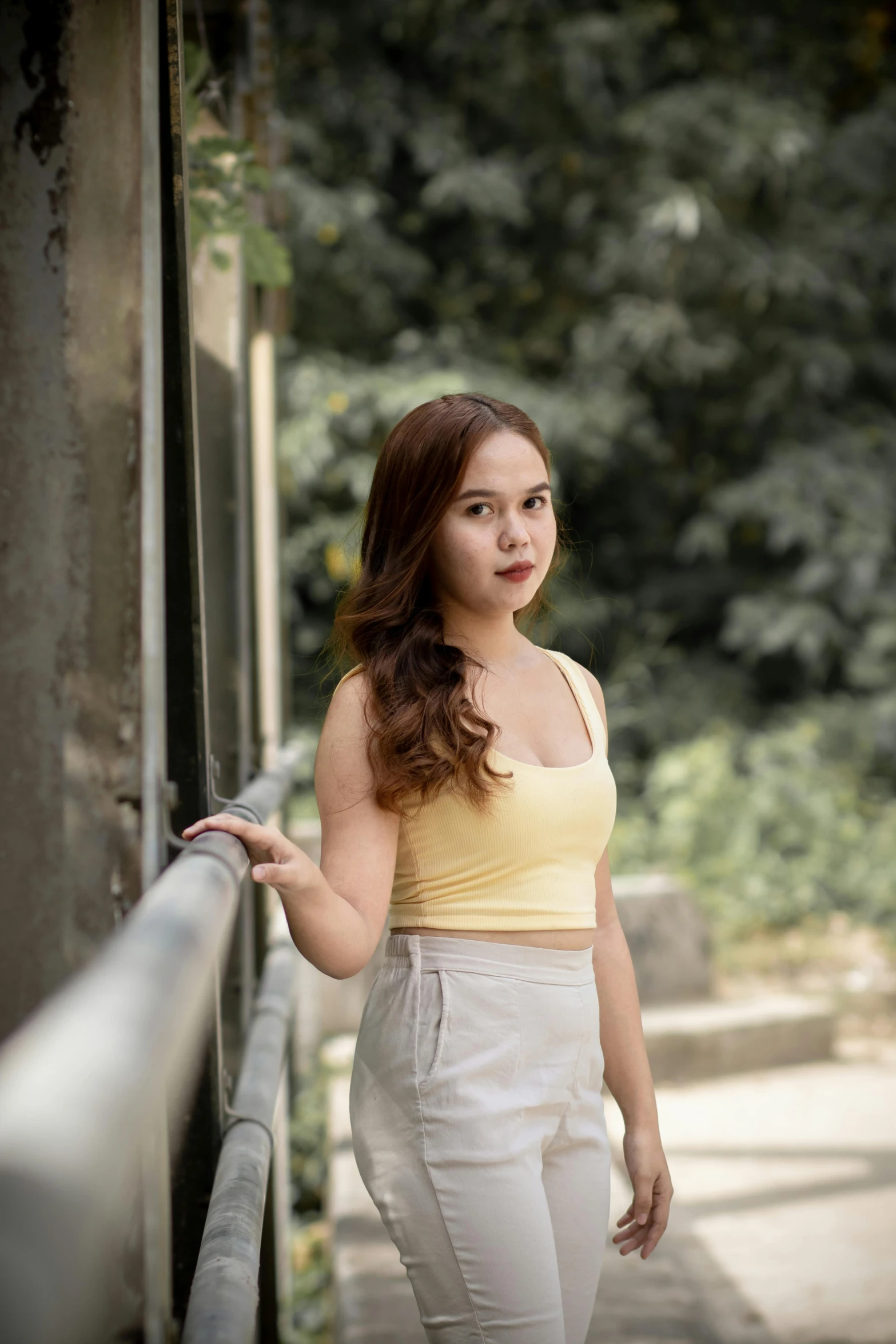 a beautiful young woman posing with her hand on her hip