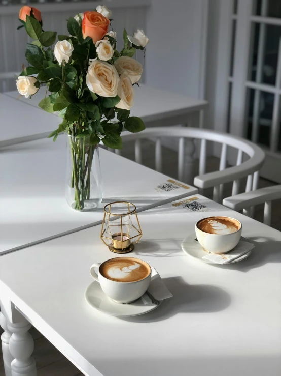 two cups and saucers are sitting on the table