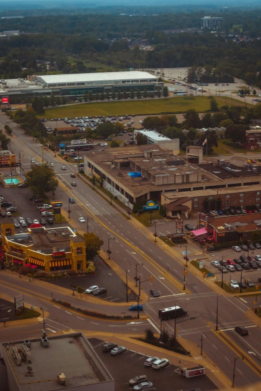an aerial s of a parking lot with cars parked around it