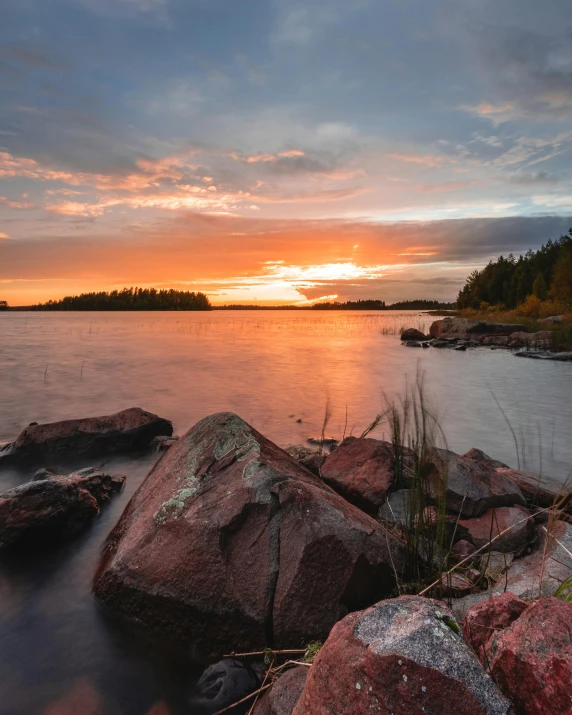 a view of the ocean at sunset from across the water