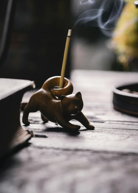 a incense hook sitting on top of a wooden table