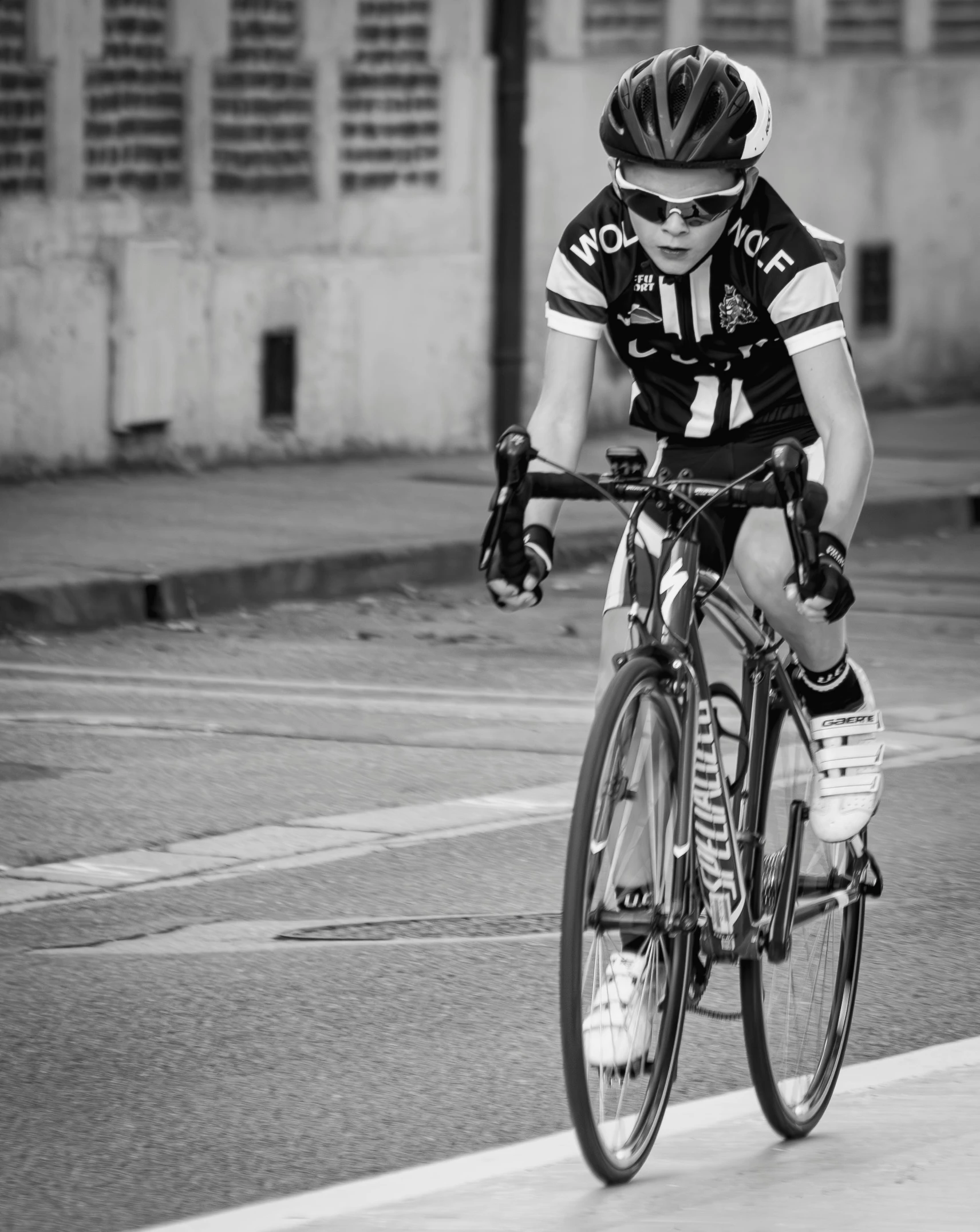 a black and white image of a cyclist