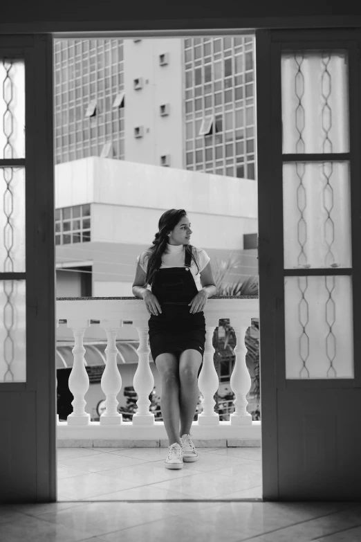 a woman walking into a balcony in the daytime