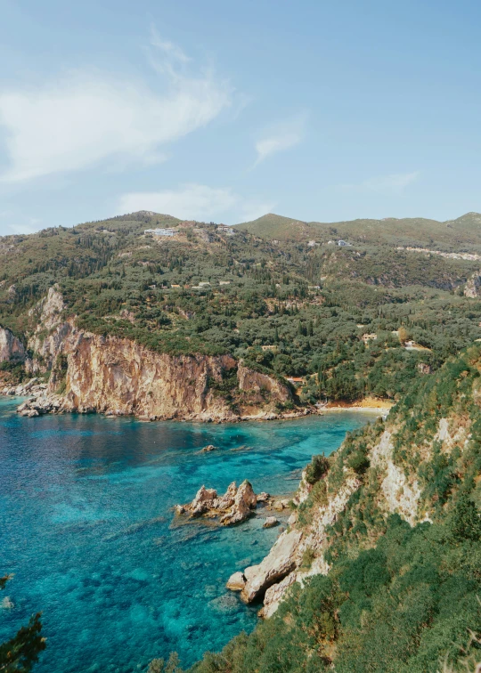 a scenic view of a rocky island with a clear blue ocean