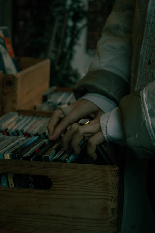 a person that is holding a drawer with many cds