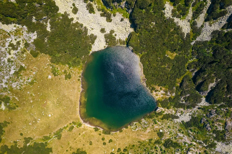 the aerial view of a lake in a valley