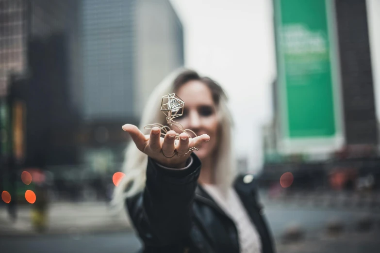 woman holding up an object in her hand