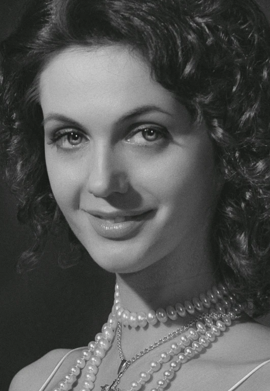 black and white pograph of woman wearing pearls