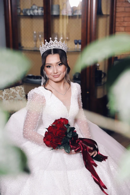 a woman in a white wedding gown holds a bouquet