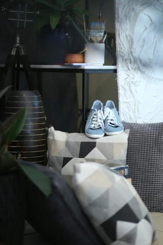 a couple of blue shoes sitting on top of a pillow