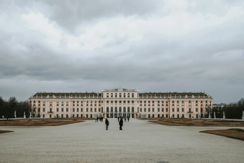 people walking through the courtyard of a big building