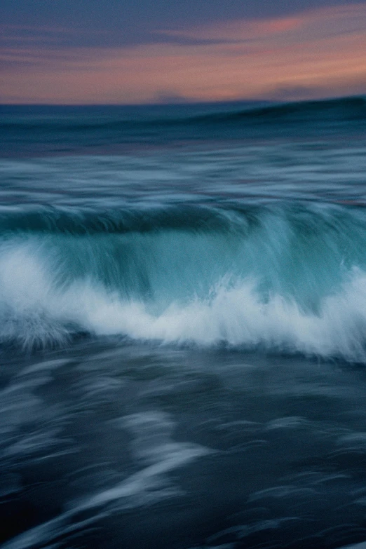 the waves are cresting over the beach