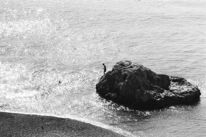 a black and white po of someone on a rock