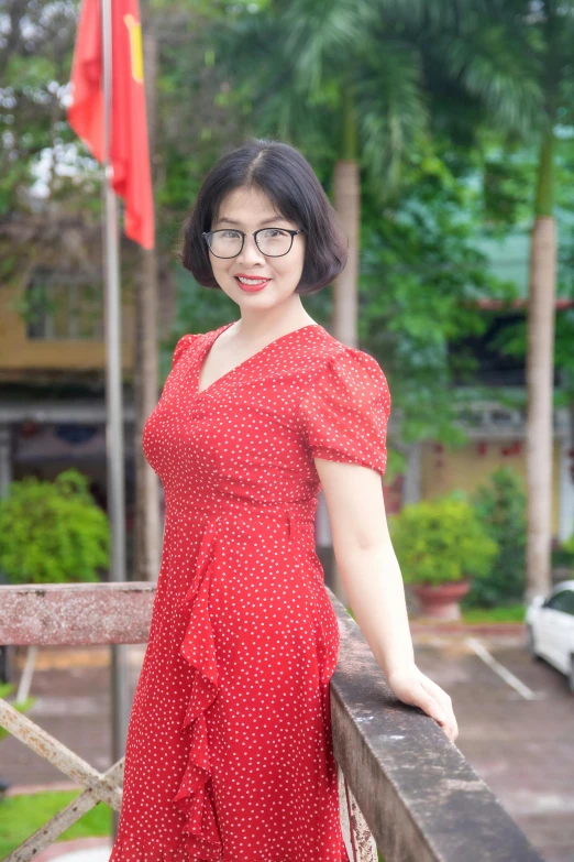 a woman posing in front of an umbrella