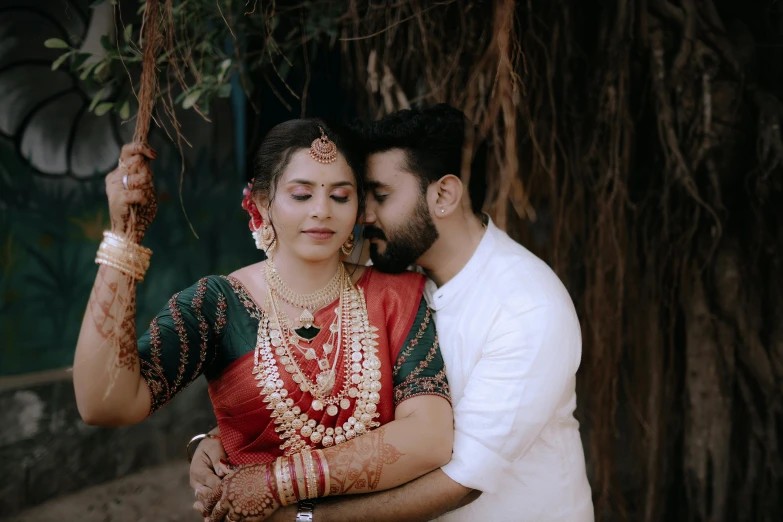 a man and woman in traditional indian attire are emcing