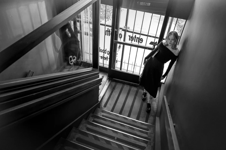 a woman walking up the stairs in an empty building