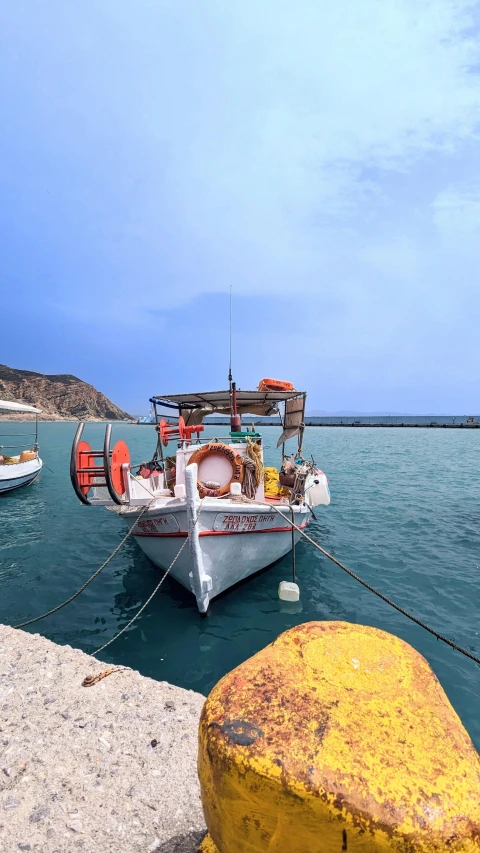 a boat that is in the water next to other boats