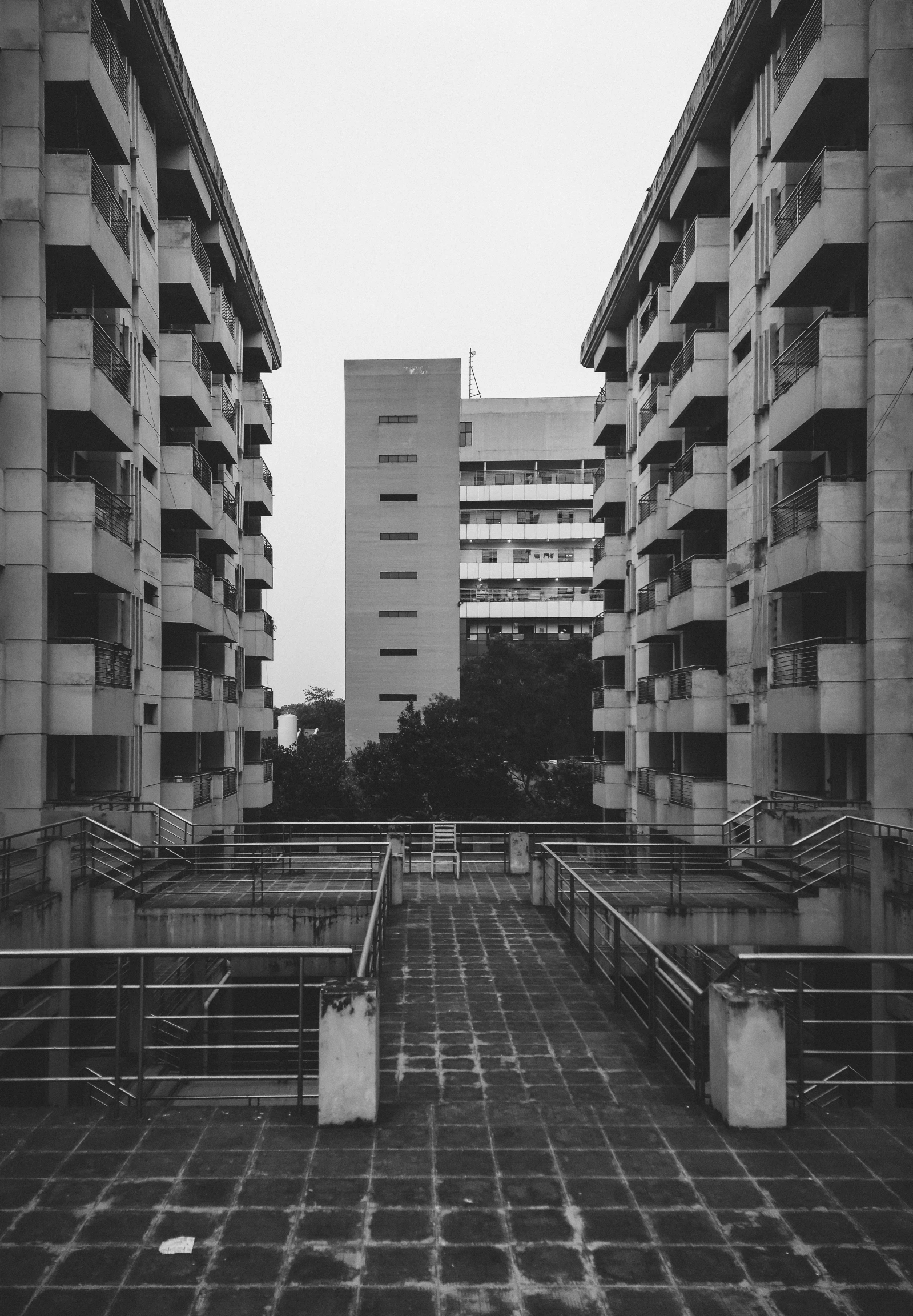 black and white po of benches in front of a building