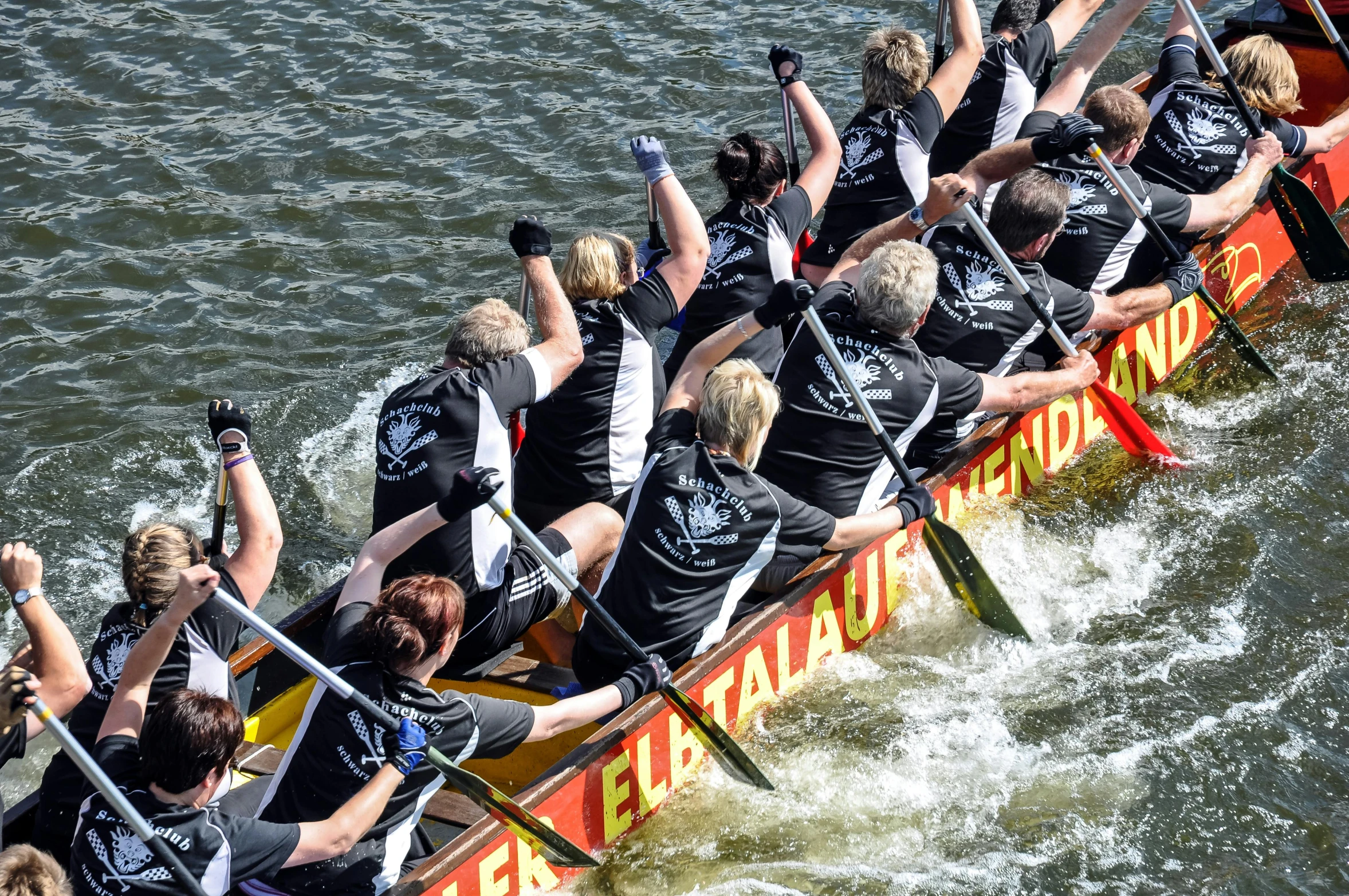 a group of people rowing on top of a boat