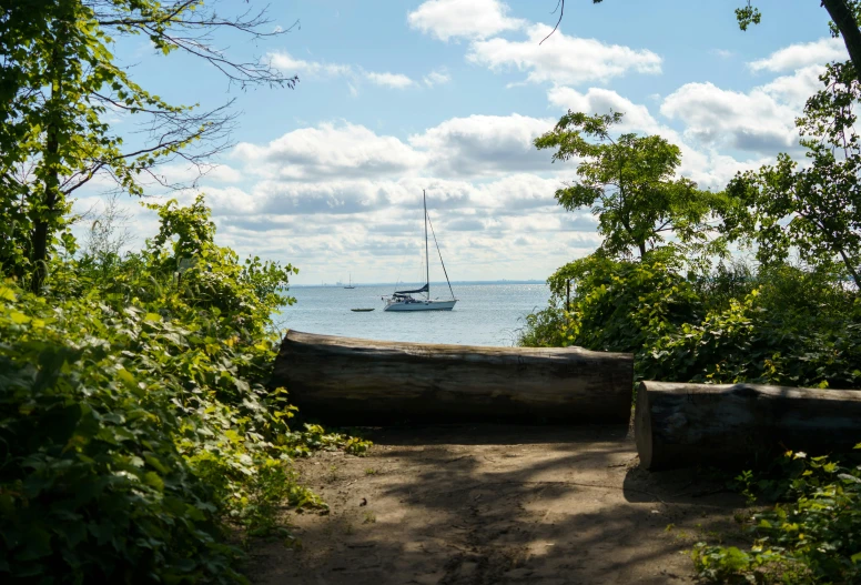 there is a boat sitting in the water at anchor