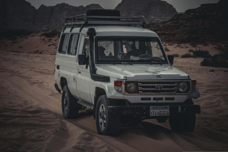 a white van parked on a sand dune