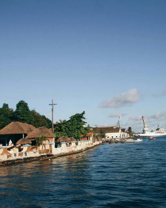 boats docked in front of a home on the water