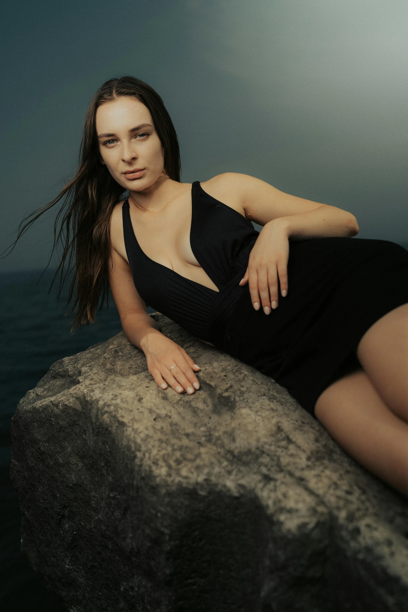 an image of a woman sitting on a rock