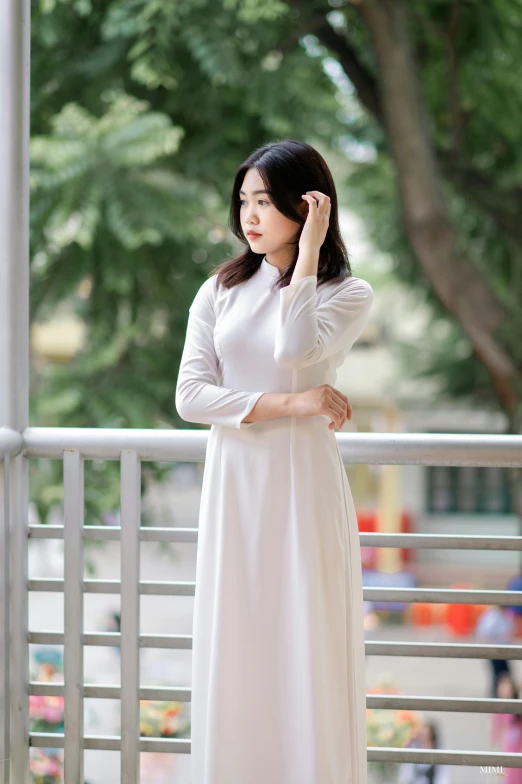 a woman in white standing on a white metal structure