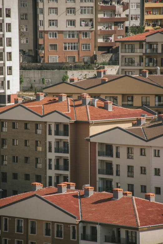 a lot of building are in the foreground and one has orange tiles on its roofs