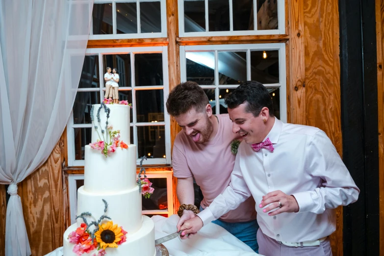 two people are  into a large cake