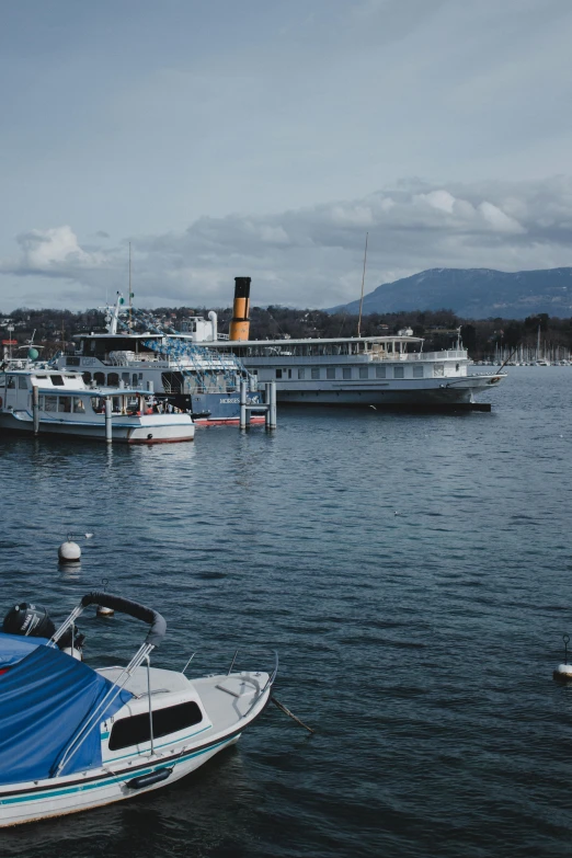 boats and ships in the water next to each other