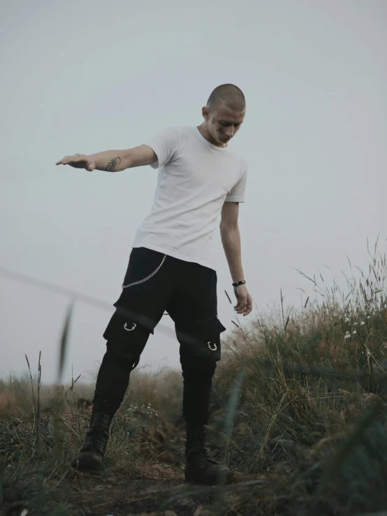 a man standing on the grass with his arms out