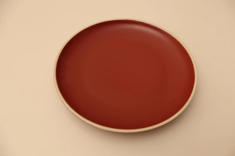 a red plate is sitting on the table