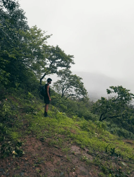 a person walking up a hill with a backpack