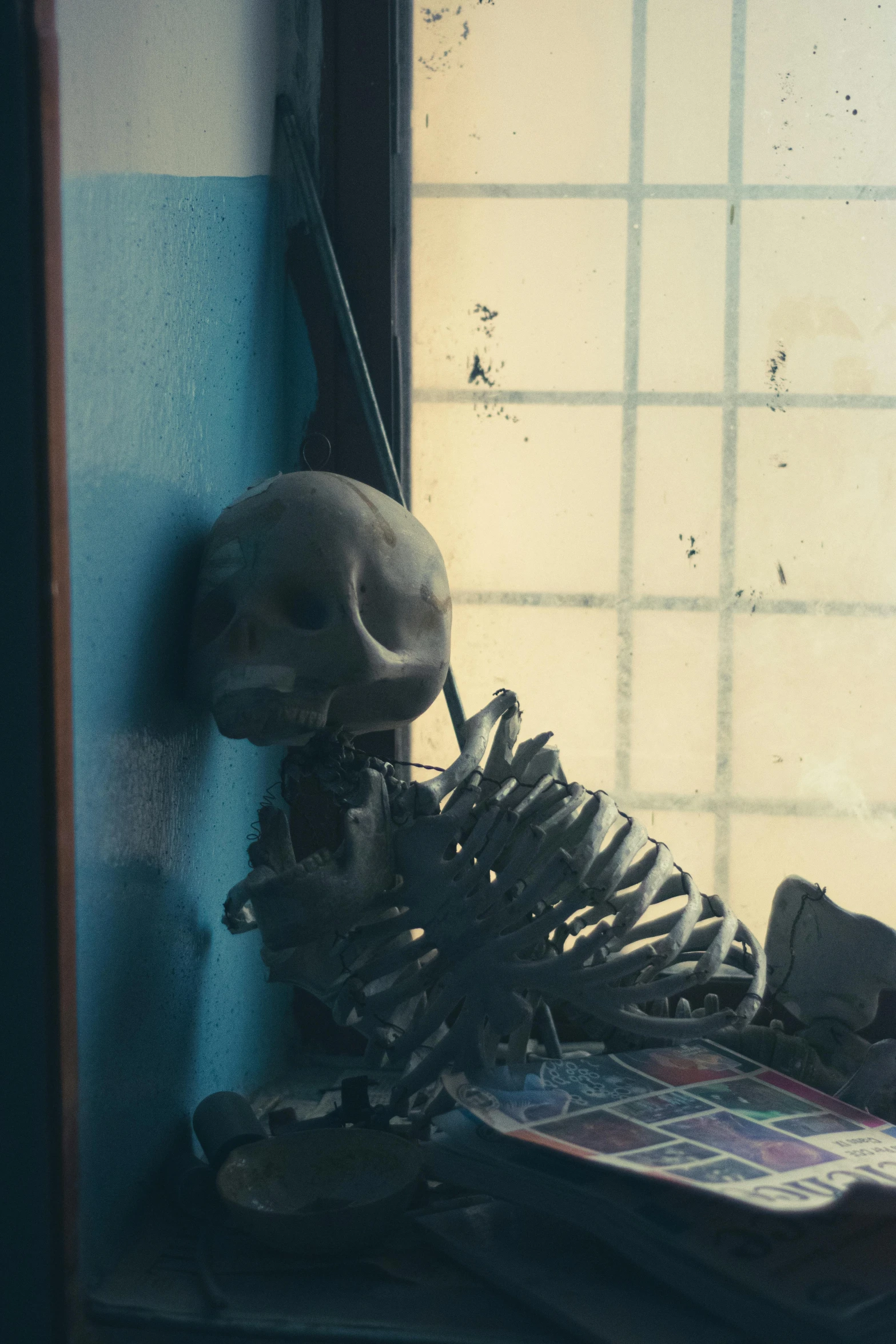 a broken shoe sits on the floor next to an old window