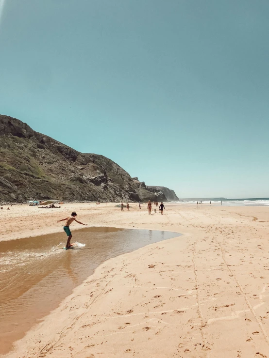 some people in the water and two people walking