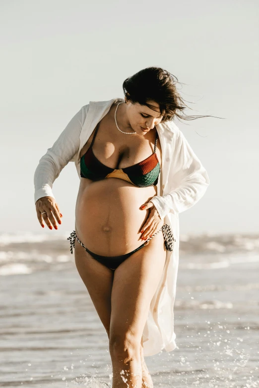 woman in bathing suit standing in the ocean