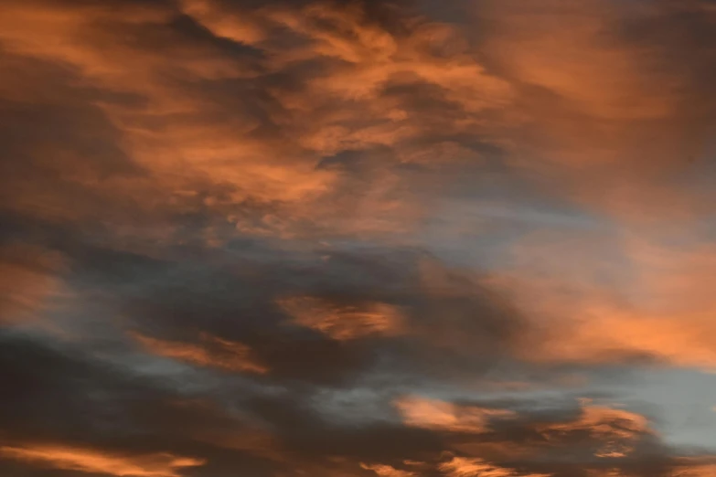 the sunset is shining red and white and the clouds are black