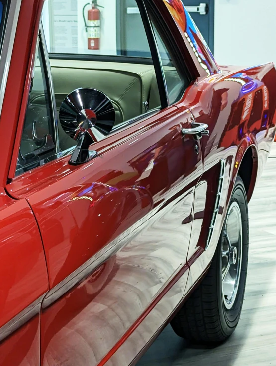 a car in a showroom showing the back wing end and center wheel