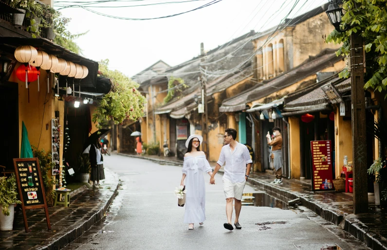 the couple is walking down the road with each other