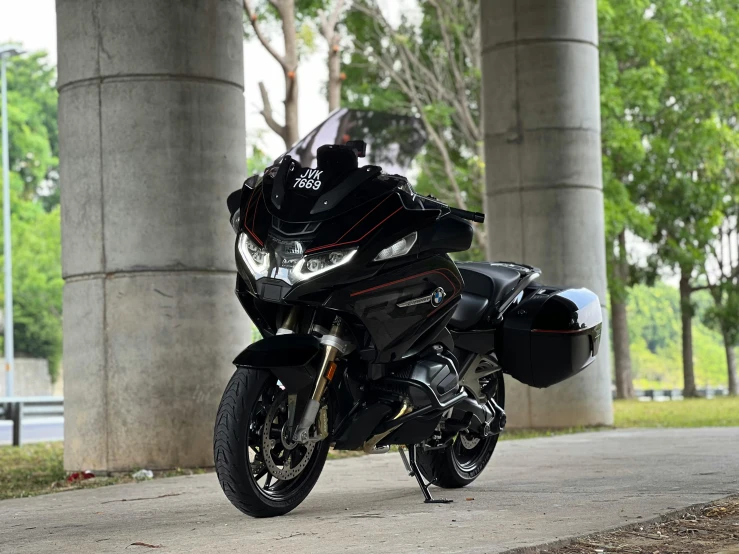 motorcycle parked in front of several large pillars