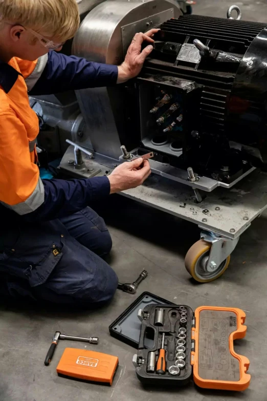 a person works on an engine in a garage