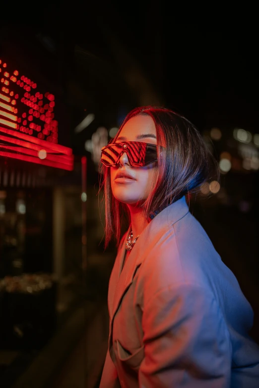 a woman with red sun glasses looks up at the sky