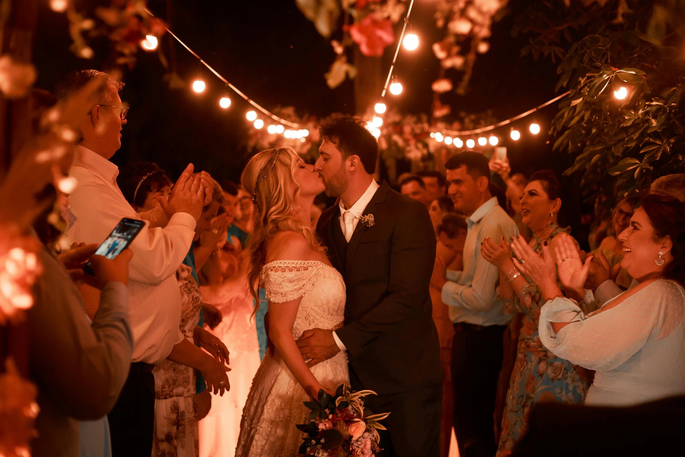 a couple kiss and take a kiss in front of an audience