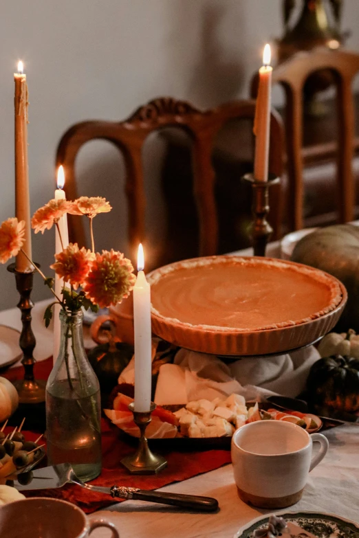 a table set up with plates and candles