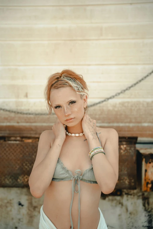 a woman with white paint on her face and chest, wearing lingerie