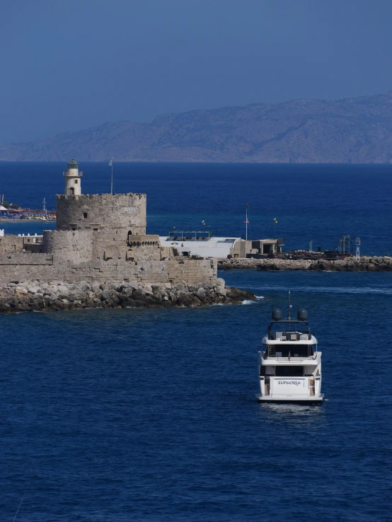 a ship is in the ocean near an island