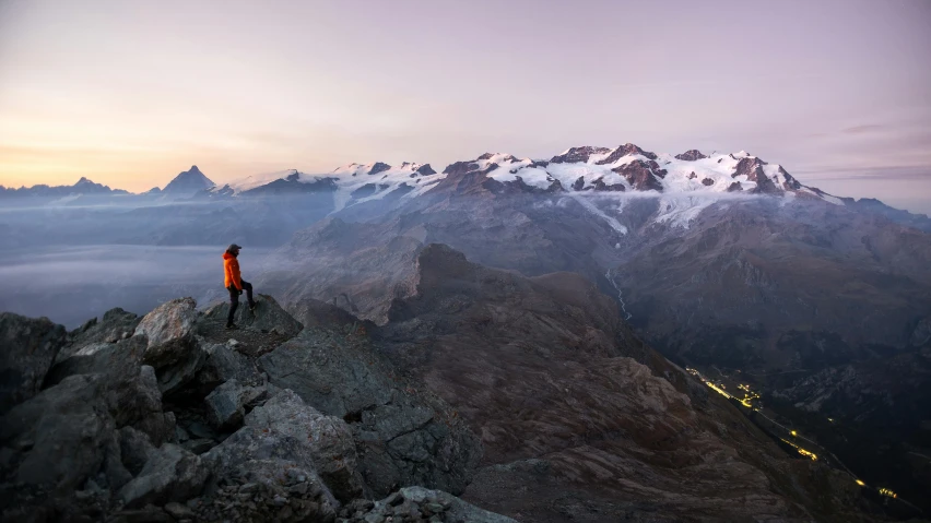 a person standing on top of a rock mountain