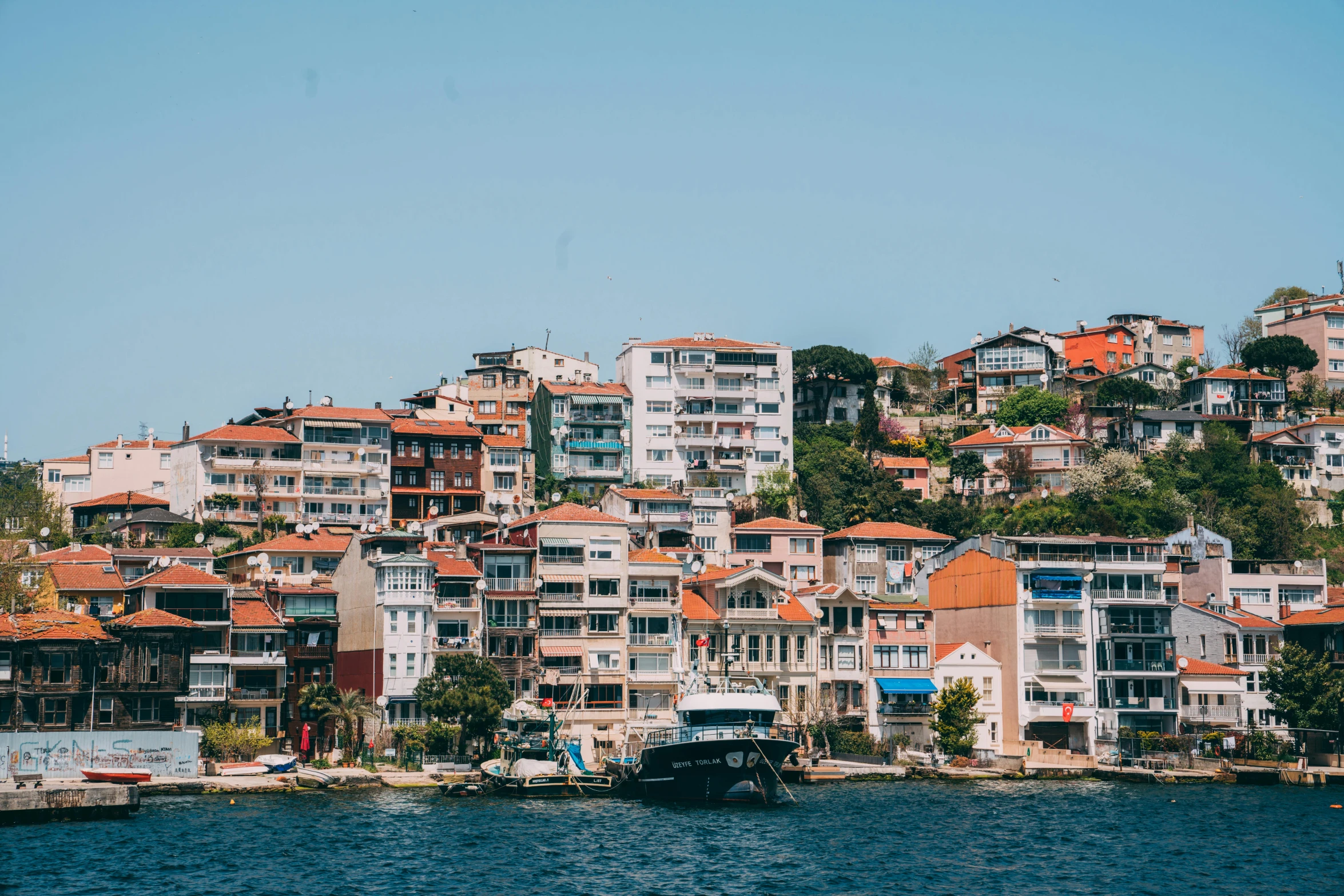 a city with lots of houses sitting next to the water