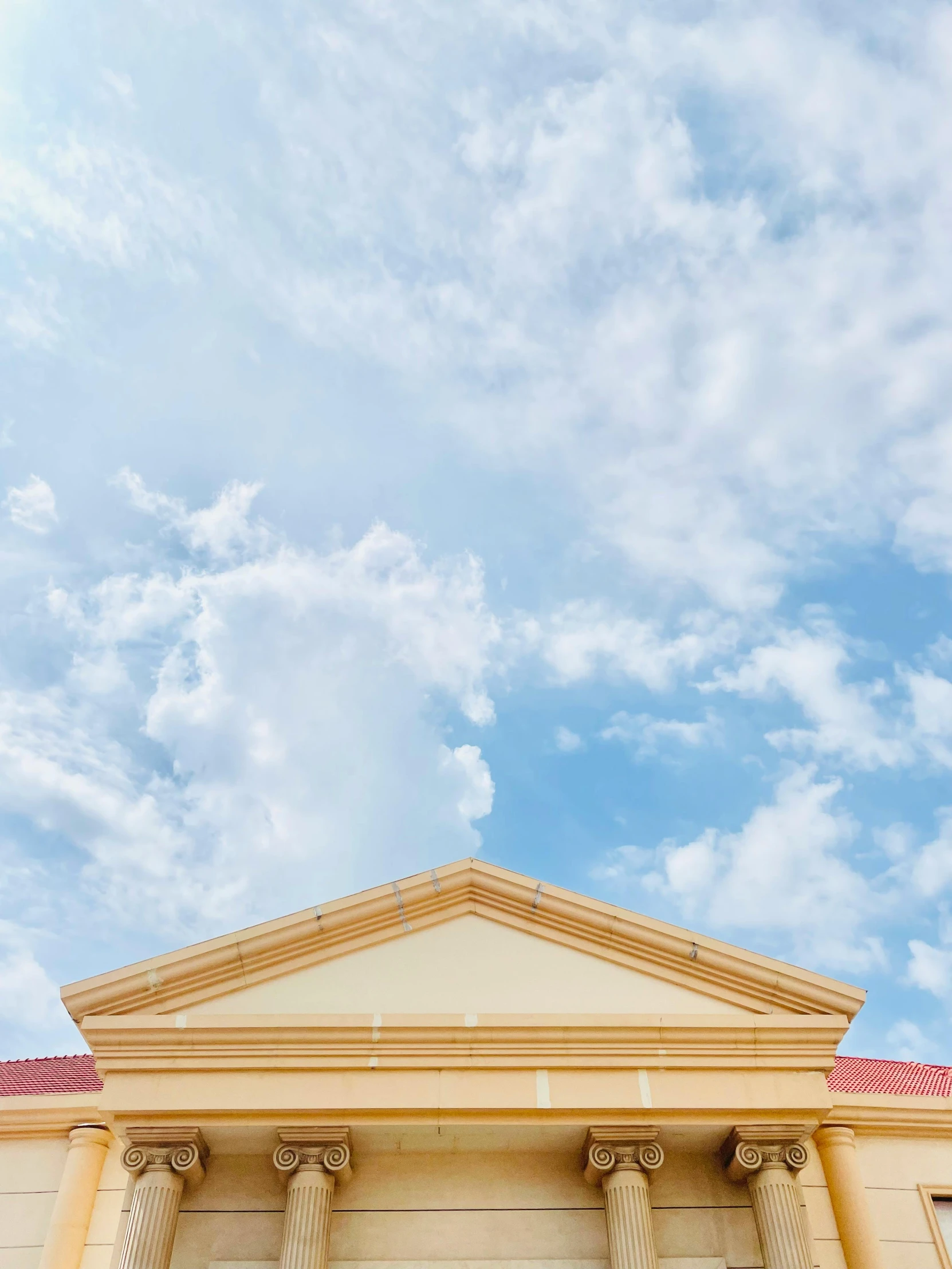 a very tall building sitting below a blue sky